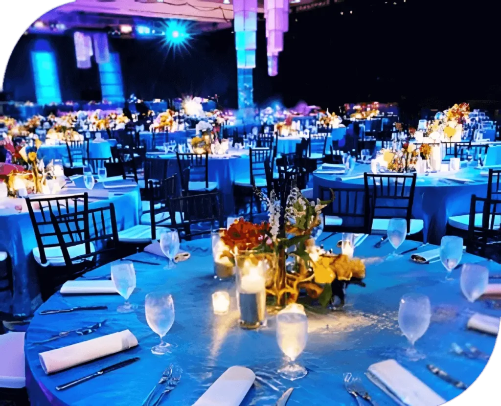 Rockys Entertainment, Event Management in Goa, Event Management Company in Goa - A banquet room with blue tables and chairs, set for an elegant event.